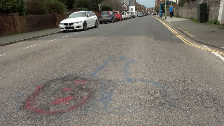 Town divided over ‘balls’ being painted in pothole protest